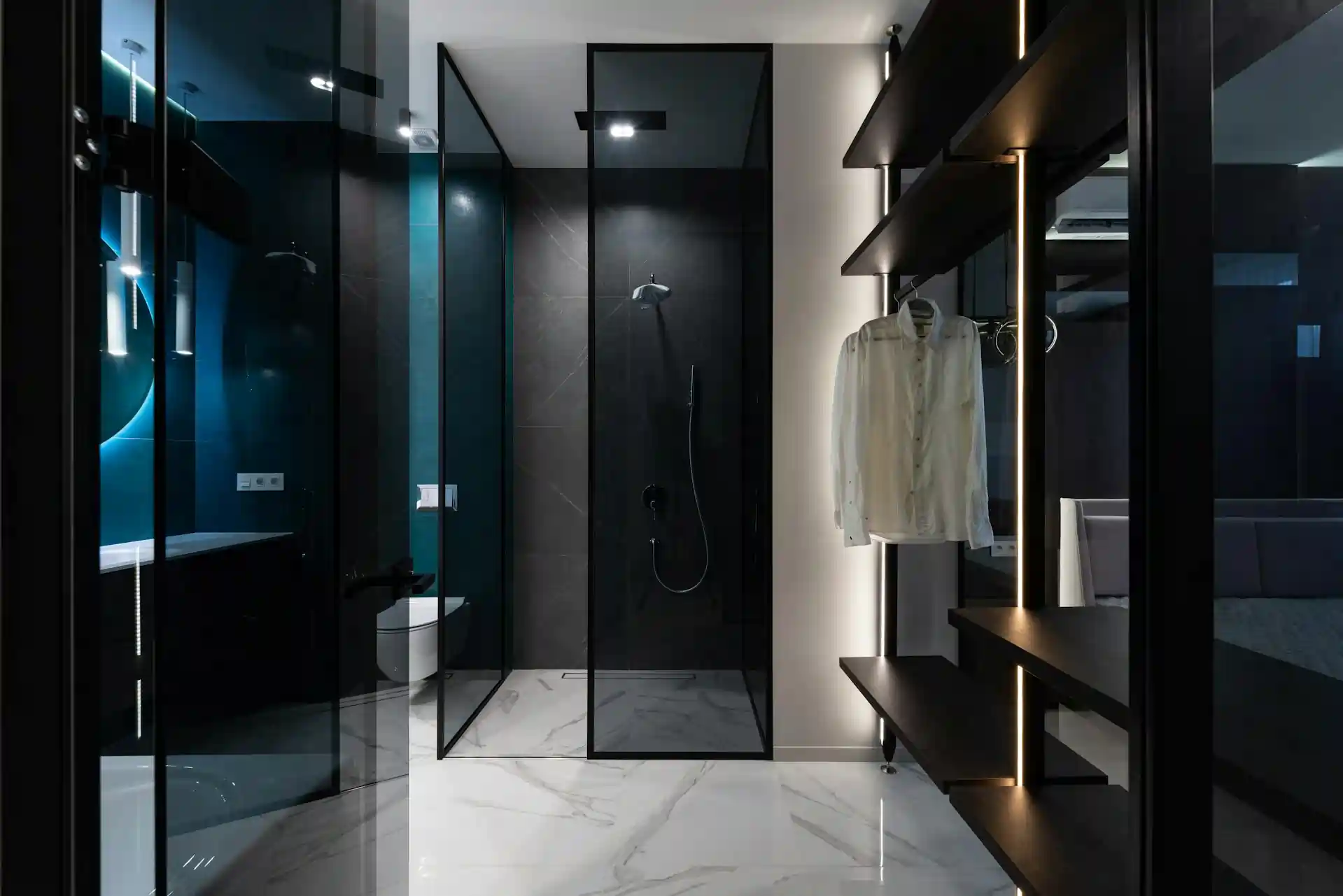 Sleek luxury bathroom with a glass shower and integrated custom closet, highlighting Blue Mountain Contractors' modern home interior design