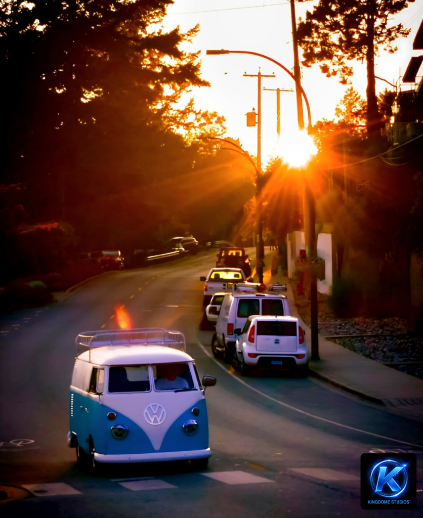 A classic blue and white VW van cruises down a sun-drenched street. Best Website Photography and Videography Abbotsford BC by KingdomeStudios.com captures the golden hour glow and style